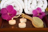 dry skin brush with candles and orchids on tray